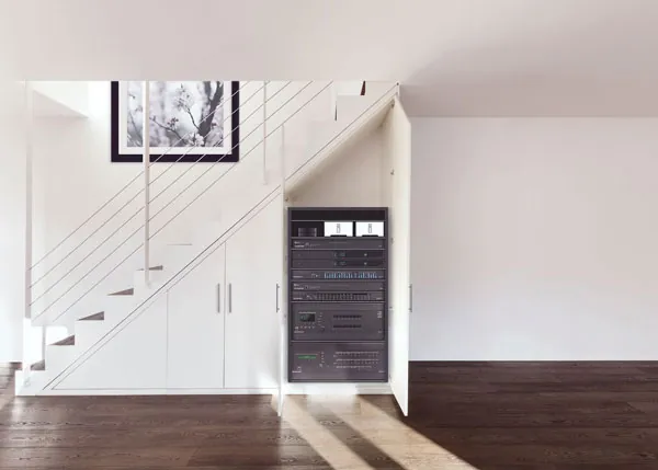 Bright entry with staircase and built-in cabinetry housing home technology