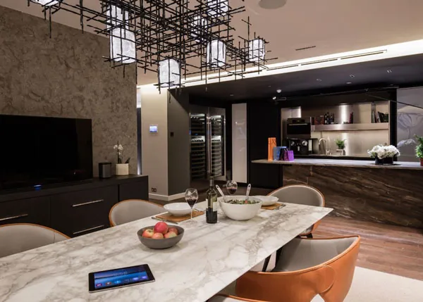 Open kitchen and dining area with an integrated touch panel on the counter